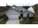 Two-story house with gray exterior and a white garage door at 507 Cassia Dr, Davenport, FL 33897