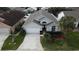 Two-story house with gray exterior and a white garage door at 507 Cassia Dr, Davenport, FL 33897