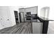 Modern kitchen with gray cabinets, stainless steel appliances, and granite countertops at 507 Cassia Dr, Davenport, FL 33897