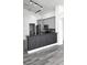 Modern kitchen with grey cabinets and breakfast bar at 507 Cassia Dr, Davenport, FL 33897