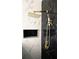 Shower with gold fixtures and marble tile surround at 507 Cassia Dr, Davenport, FL 33897