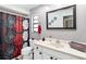 Bathroom with shower/tub, sink, and floral shower curtain at 508 Bar Dr, Kissimmee, FL 34759