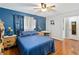 Bedroom with blue bedding and wooden furniture at 508 Bar Dr, Kissimmee, FL 34759