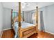 Bedroom with a wooden post bed and window at 508 Bar Dr, Kissimmee, FL 34759