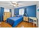 Bedroom with blue bedding and wooden furniture at 508 Bar Dr, Kissimmee, FL 34759