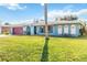 Light blue house with red garage door and lush green lawn at 508 Bar Dr, Kissimmee, FL 34759