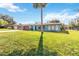 Ranch style home with red garage door and nicely landscaped lawn at 508 Bar Dr, Kissimmee, FL 34759