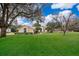 Single-story house with a large yard, driveway, and mature trees at 5323 Mill Stream Dr, St Cloud, FL 34771