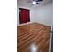 Spacious bedroom with wood flooring and red curtains at 56 Buck Cir, Haines City, FL 33844