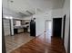 Eat-in kitchen with wood flooring and access to hallway at 56 Buck Cir, Haines City, FL 33844