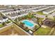 Aerial view of community pool, playground, and homes at 592 Madison Dr, Davenport, FL 33837