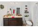 Clean bathroom with dark vanity, toilet and shower/tub combo at 592 Madison Dr, Davenport, FL 33837