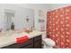 Bathroom with dark vanity, toilet and shower/tub combo at 592 Madison Dr, Davenport, FL 33837