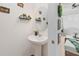 Stylish powder room with pedestal sink, oval mirror and decorative accents at 592 Madison Dr, Davenport, FL 33837