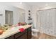 Bathroom with dark vanity, toilet and shower/tub combo at 592 Madison Dr, Davenport, FL 33837