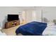Bedroom with large bed, TV stand, and access to bathroom at 592 Madison Dr, Davenport, FL 33837