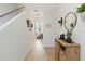 Light-filled hallway with stairs, wood-look floors, and wall decor at 592 Madison Dr, Davenport, FL 33837