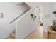 Light-filled hallway with stairs, wood-look floors, and wall decor at 592 Madison Dr, Davenport, FL 33837