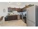 Modern kitchen with dark cabinets, stainless steel appliances, and granite countertops at 592 Madison Dr, Davenport, FL 33837