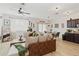 Open-concept living room with brown sectional sofa and a dining area at 592 Madison Dr, Davenport, FL 33837