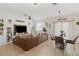 Open living space with brown sectional sofa, dining area, and sliding door at 592 Madison Dr, Davenport, FL 33837