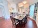 Formal dining room with hardwood floors and a glass-top dining table at 612 Grand Canal Dr, Poinciana, FL 34759