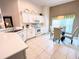 White kitchen features a breakfast bar and an eat-in area at 612 Grand Canal Dr, Poinciana, FL 34759