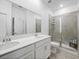 Modern bathroom with double vanity, large shower and neutral color scheme at 6308 Chirpine Ln, St Cloud, FL 34771