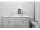Bathroom with double vanity and white cabinets at 6308 Chirpine Ln, St Cloud, FL 34771