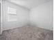 Simple bedroom with carpeted floor and window with blinds at 6308 Chirpine Ln, St Cloud, FL 34771