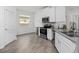 White kitchen with stainless steel appliances and gray countertops at 6308 Chirpine Ln, St Cloud, FL 34771