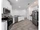 Modern kitchen featuring stainless steel appliances and gray countertops at 6308 Chirpine Ln, St Cloud, FL 34771