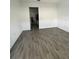 Open living room with wood-look tile floors at 6308 Chirpine Ln, St Cloud, FL 34771