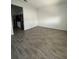 Open living room with wood-look tile floors at 6308 Chirpine Ln, St Cloud, FL 34771