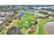 Aerial view of an attractive community, with a beautiful golf course with lakes and tree lined streets at 6921 Cupseed Ln, Harmony, FL 34773