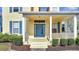 Inviting front porch with a blue front door and white railings, perfect for enjoying the neighborhood view at 6921 Cupseed Ln, Harmony, FL 34773