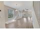 Bright living room featuring wood-look floors, ample windows, and a modern ceiling fan at 6921 Cupseed Ln, Harmony, FL 34773