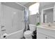 Bathroom featuring a white tub, blue paisley curtain, a toilet and a sink at 760 Lake Marion Golf Resort, Poinciana, FL 34759