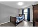 Cozy bedroom features wood-look floors, window with blue curtains at 760 Lake Marion Golf Resort, Poinciana, FL 34759