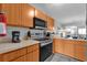 Modern kitchen showcasing stainless steel appliances, ample counter space, and light wood cabinetry at 760 Lake Marion Golf Resort, Poinciana, FL 34759