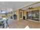 Spacious screened lanai with tile flooring, ceiling fan, and sliding door access to the house, ideal for outdoor living at 760 Lake Marion Golf Resort, Poinciana, FL 34759