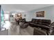 Cozy living room with hardwood floors, plush seating, and an open layout leading to the dining area and kitchen at 760 Lake Marion Golf Resort, Poinciana, FL 34759