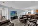 Open-concept living room with modern flooring, comfortable leather seating, and seamless access to the dining area at 760 Lake Marion Golf Resort, Poinciana, FL 34759