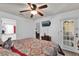 Spacious main bedroom featuring a comfortable bed, ceiling fan, and a view of the en-suite bathroom at 760 Lake Marion Golf Resort, Poinciana, FL 34759