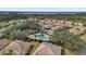 Community pool with surrounding lounge chairs and a clubhouse nearby at 760 Lake Marion Golf Resort, Poinciana, FL 34759