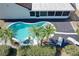 Aerial view showcasing a kidney-shaped pool and surrounding landscape at 8079 Cloverglen Cir, Orlando, FL 32818
