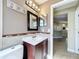 Clean bathroom with a single sink vanity and toilet at 8079 Cloverglen Cir, Orlando, FL 32818