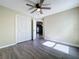 Light-filled bedroom with grey laminate wood flooring and double door closet at 8079 Cloverglen Cir, Orlando, FL 32818