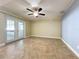 Spacious living room featuring tile flooring and sliding glass doors at 8079 Cloverglen Cir, Orlando, FL 32818