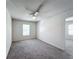 Spacious bedroom with grey carpet, ceiling fan, and window with blinds at 815 Savona Pl, Kissimmee, FL 34758